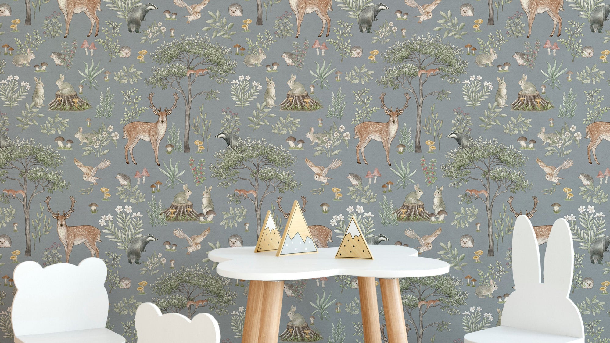 Dusty Blue Wildlife wallpaper with deer and owls behind a white cloud table with bear and bunny chairs