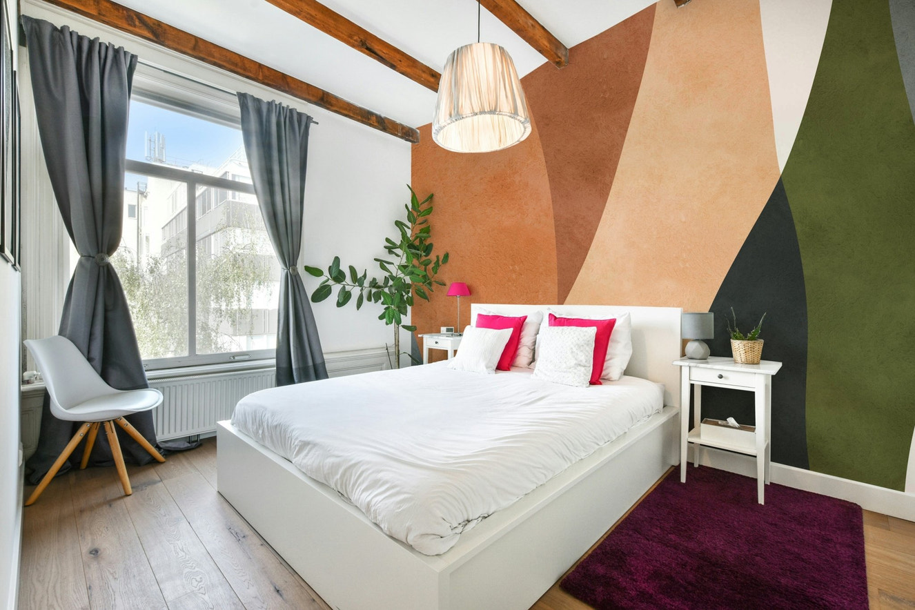 A modern wall mural with a repeating geometric arch pattern.

