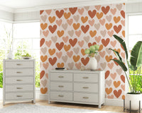 Repeating heart motifs in natural earthy shades creating a cozy, romantic wallpaper pattern.