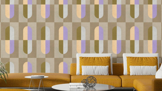 Earthy Hues wallpaper with retro olive, lilac and peach capsule shapes behind a mustard yellow sectional sofa in a living room