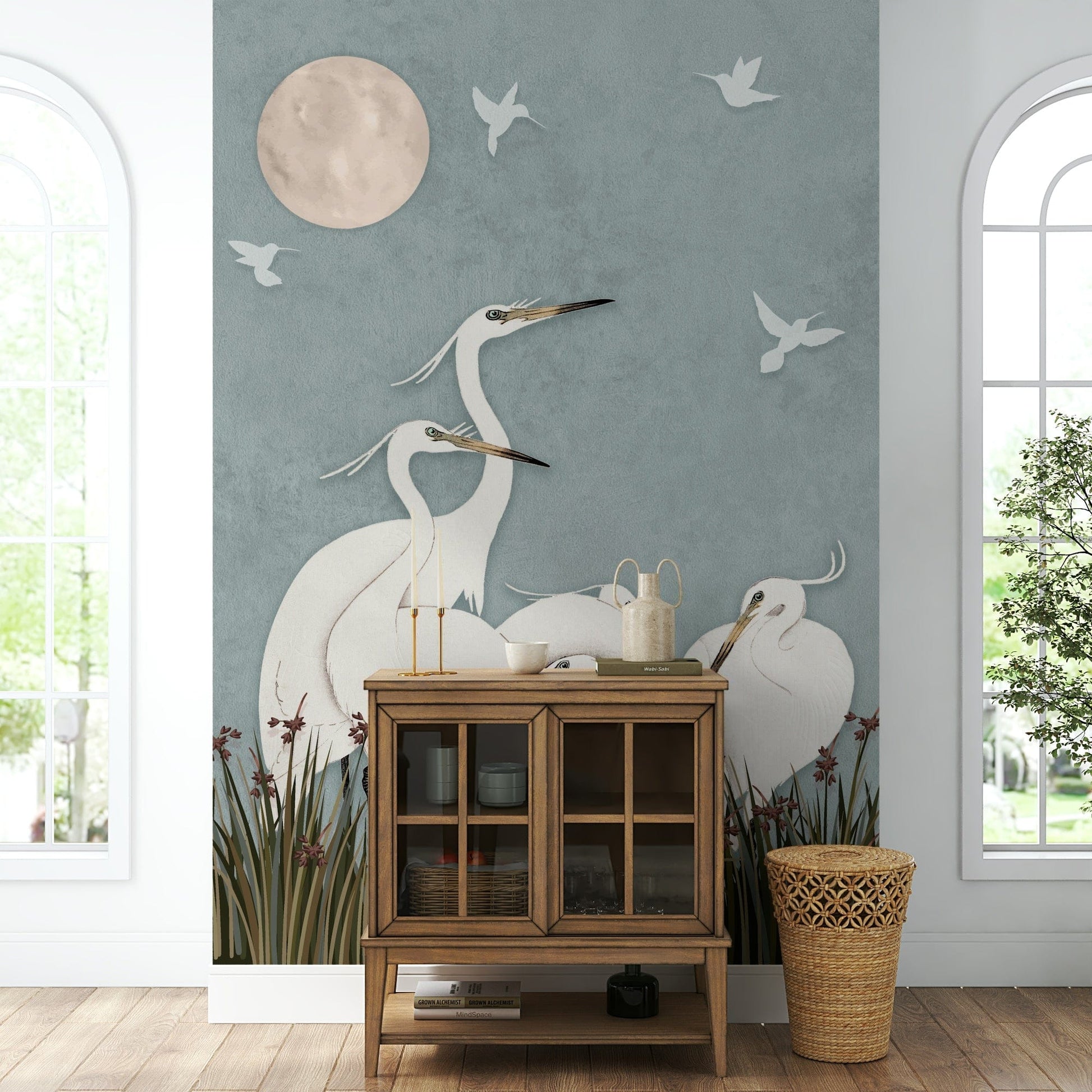 A full-wall mural of a serene night scene with egrets.
