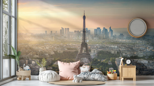 Paris City Eiffel Tower wallpaper mural at sunrise behind blush floor cushions and a wood nightstand in a living room