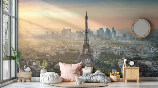 Paris City Eiffel Tower wallpaper mural at sunrise behind blush floor cushions and a wood nightstand in a living room