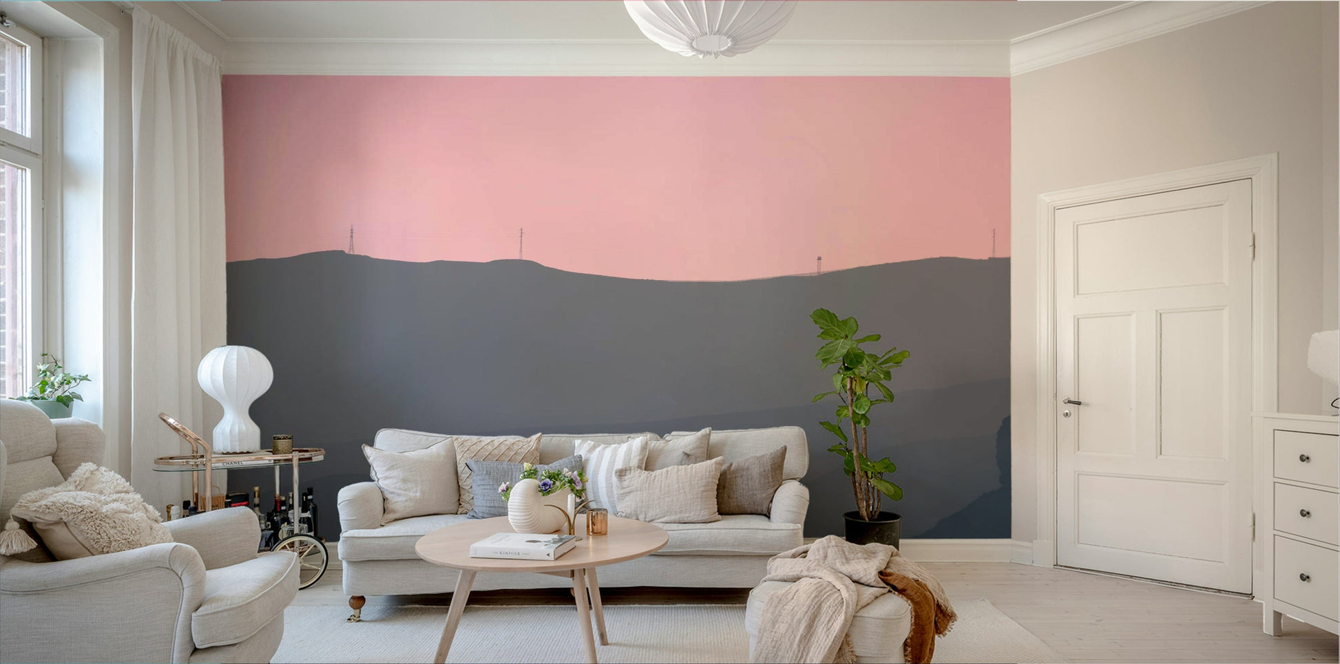 A living room with the mountain landscape wall mural.

