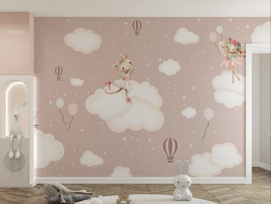 Enchanted Clouds wallpaper mural with a ballerina cat on pink clouds in a girls room with a round rug and bunny toys