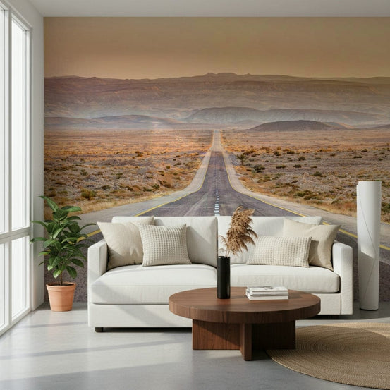 Endless Journey wallpaper mural of a desert highway behind a white sofa and walnut table in a living room