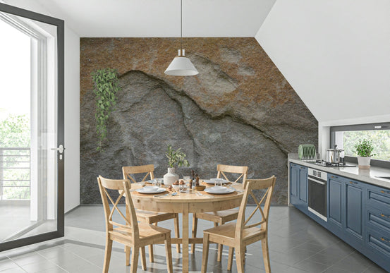 Eroded rock face wallpaper mural in a kitchen with blue cabinets and a light wood round dining table