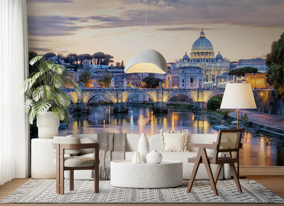 Eternal City Lights wallpaper mural of Rome's St Peter's dome and lit bridge above a cream curved sofa and monstera