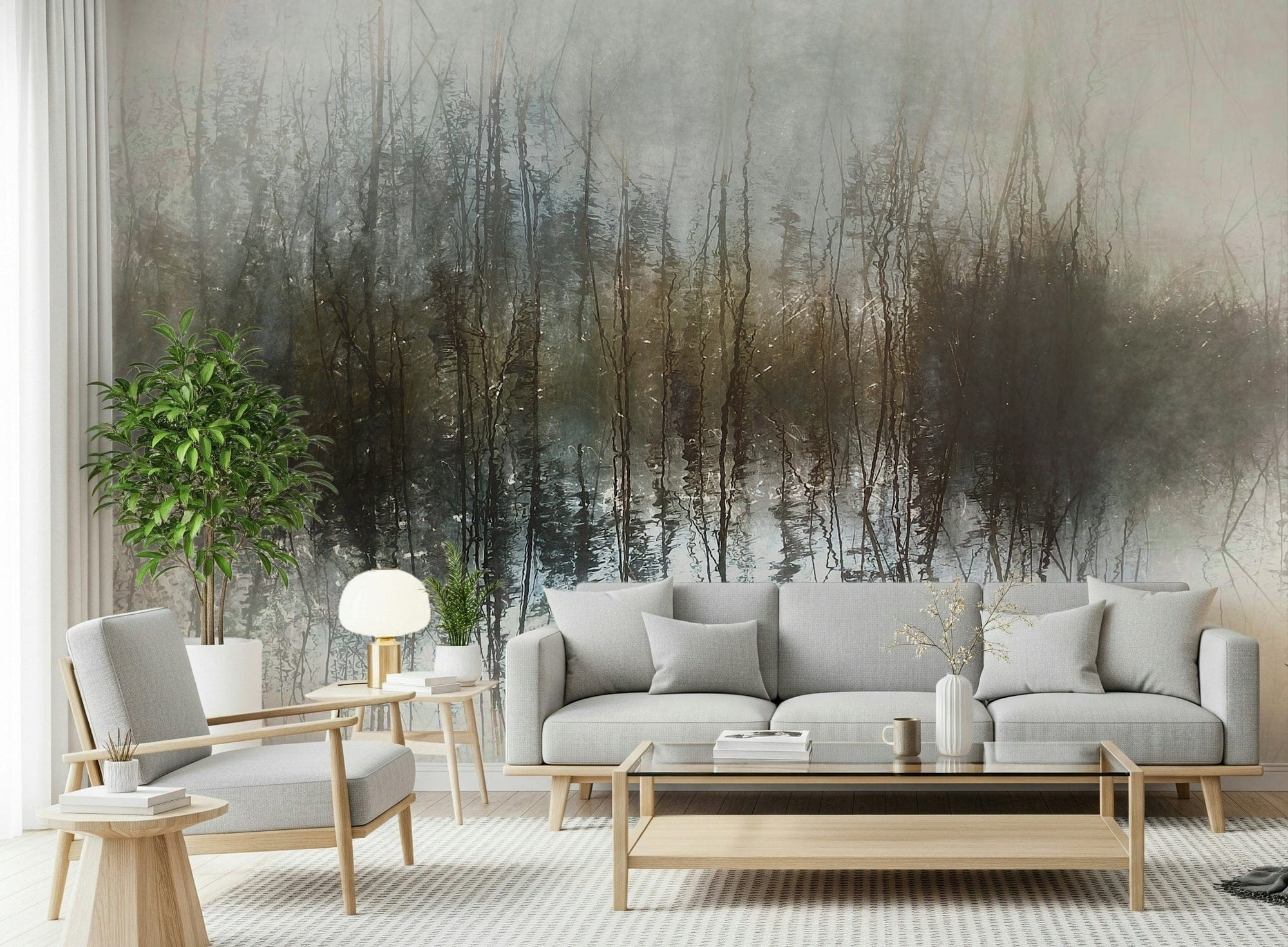 Ethereal Reflection wallpaper mural of misty treeline mirrored in water behind a grey sofa and wood armchair
