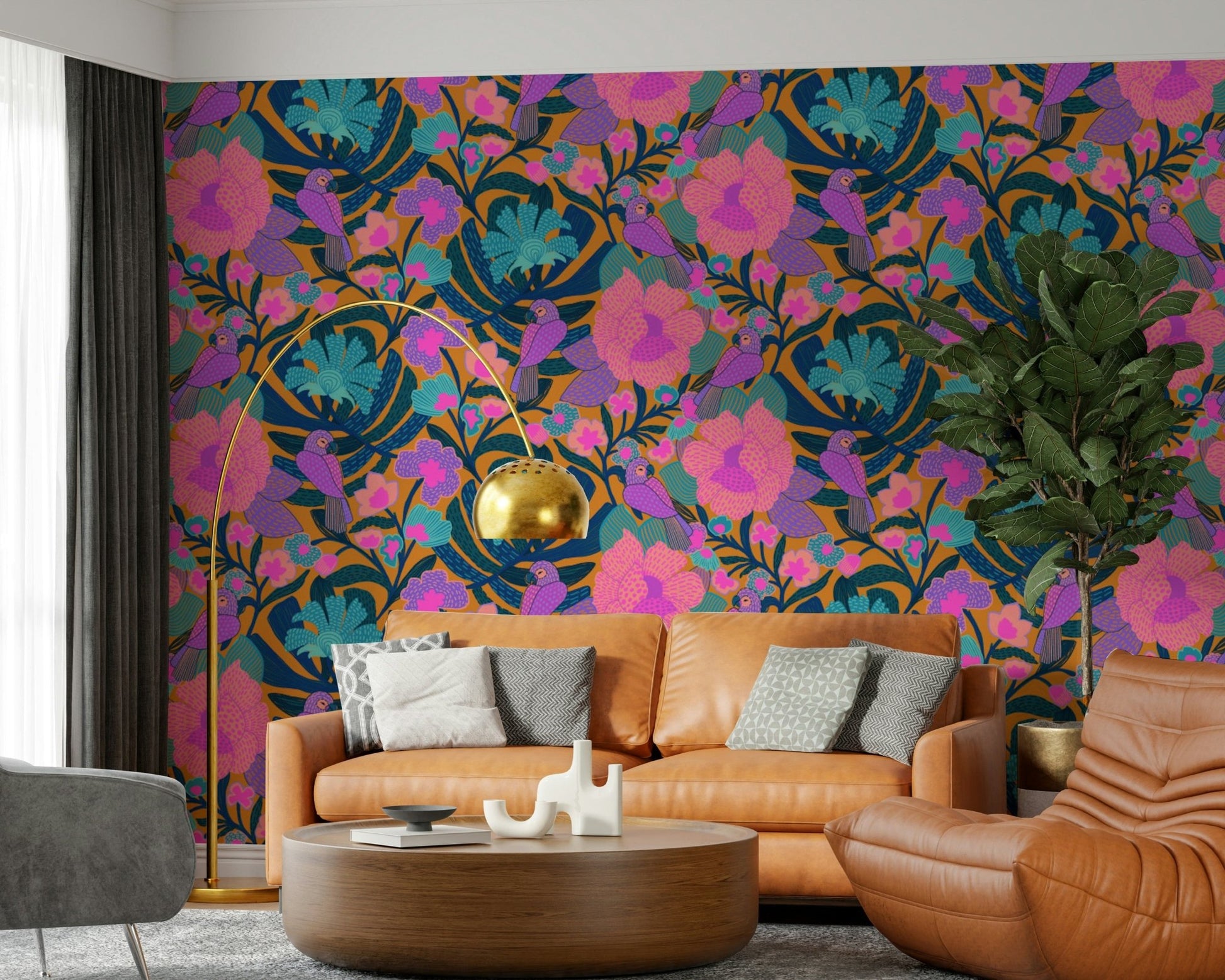 Exotic Bloom wallpaper with purple parrots and pink flowers behind a caramel leather sofa and gold arc lamp