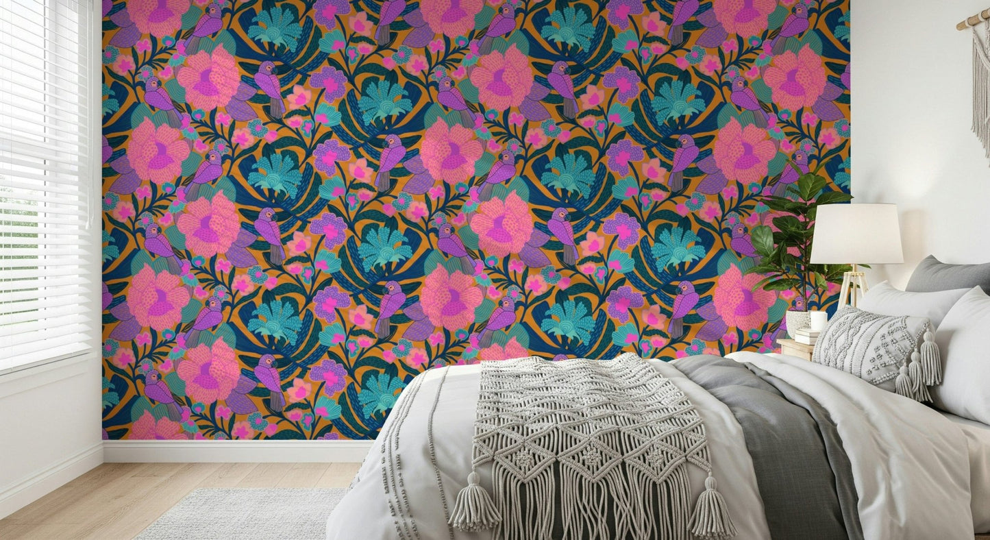 Exotic Bloom wallpaper behind a white and grey bed with a macrame throw and bedside lamp
