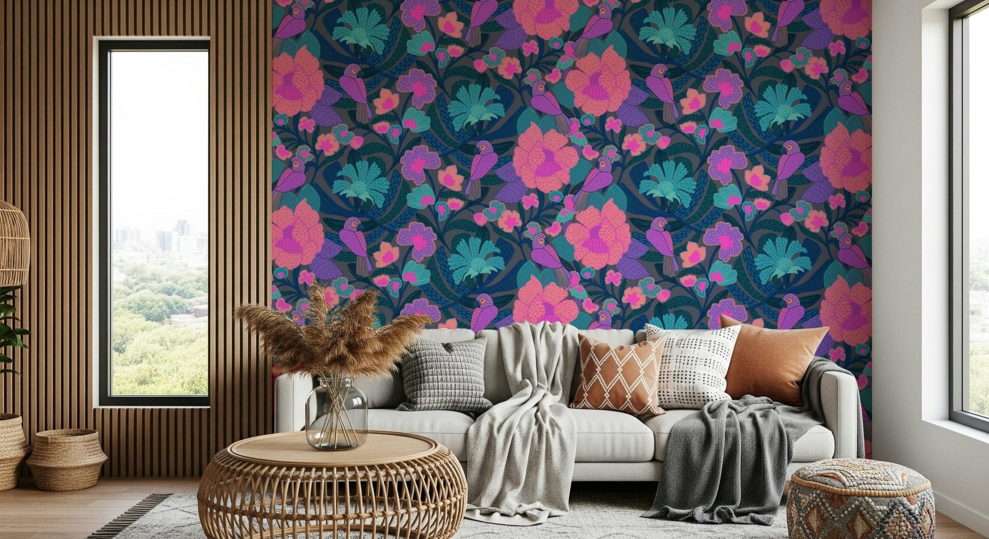 Exotic Garden wallpaper with pink and teal flowers and birds behind a grey sofa in a bright living room