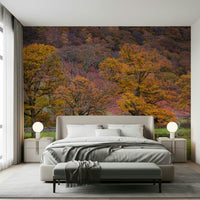 Autumn hillside wallpaper filled with deep reds, golds, and rustic tree silhouettes.