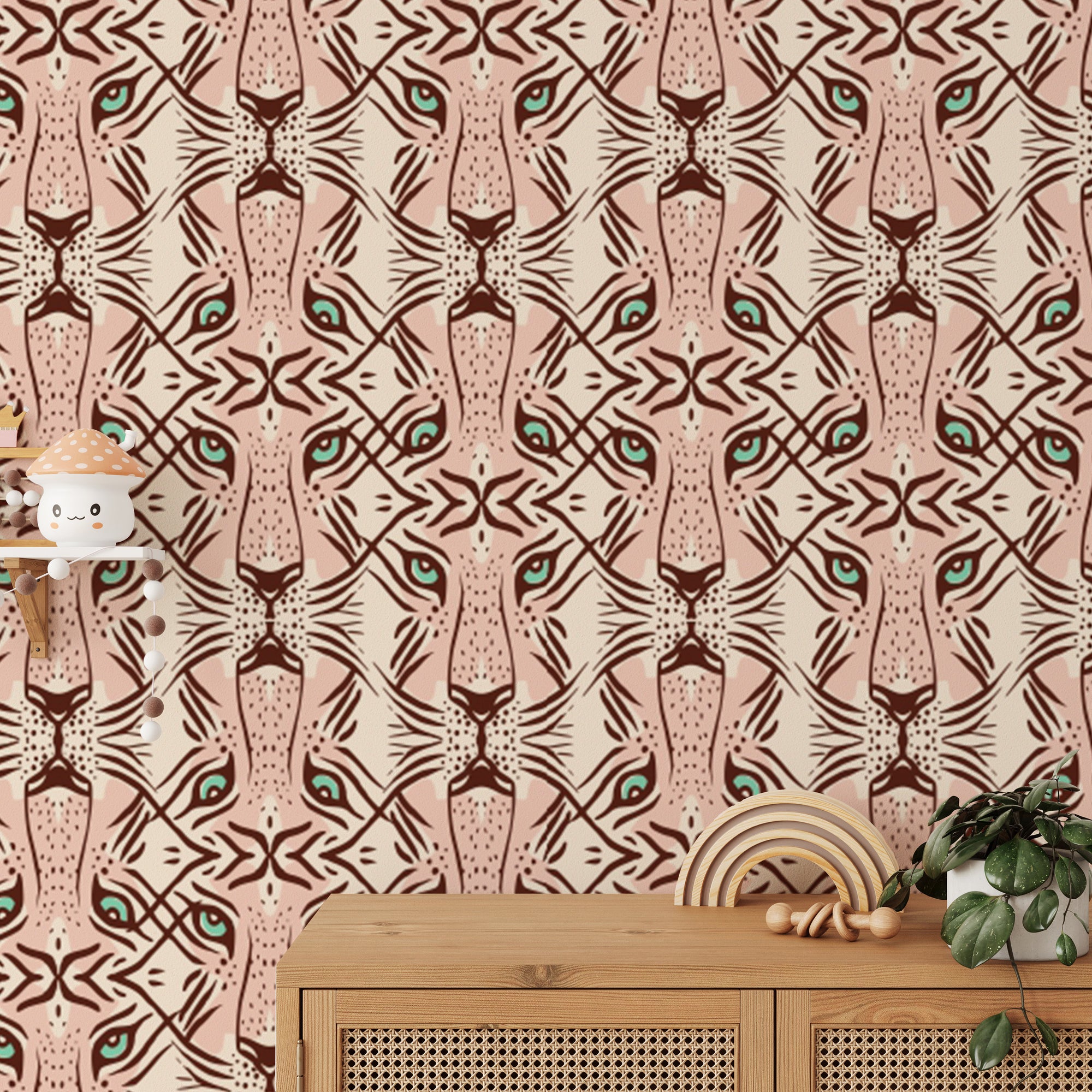 Feline Gaze Whimsical wallpaper with repeating leopard faces in blush pink and terracotta shown as a close-up pattern