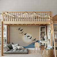 Wall mural with flamingos flying gracefully under a glowing evening sky.