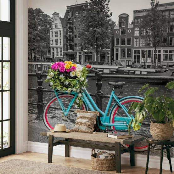 Floral Bicycle of Amsterdam wallpaper mural of a teal bike with flowers above a wood bench and monstera in an entryway