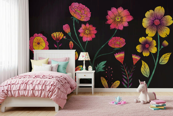 Luminous Floral Whispers wallpaper mural of glowing pink and yellow flowers on black behind a white bed with pink ruffled bedding in a girls room