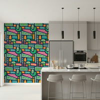 A vibrant bohemian patchwork wallpaper featuring colorful floral blocks in bright rainbow tones.