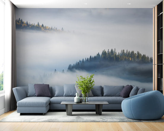 Foggy Misty Forest Maple Tree wallpaper mural behind a blue-grey sectional sofa and beanbag in a living room