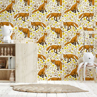 Foxes and Buttercups Wallpaper featuring playful foxes among yellow buttercup flowers on a natural white background.