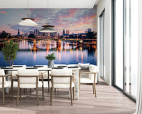 Frankfurt Dawn wallpaper mural of the lit bridge and skyline in a dining room with white chairs and pendants