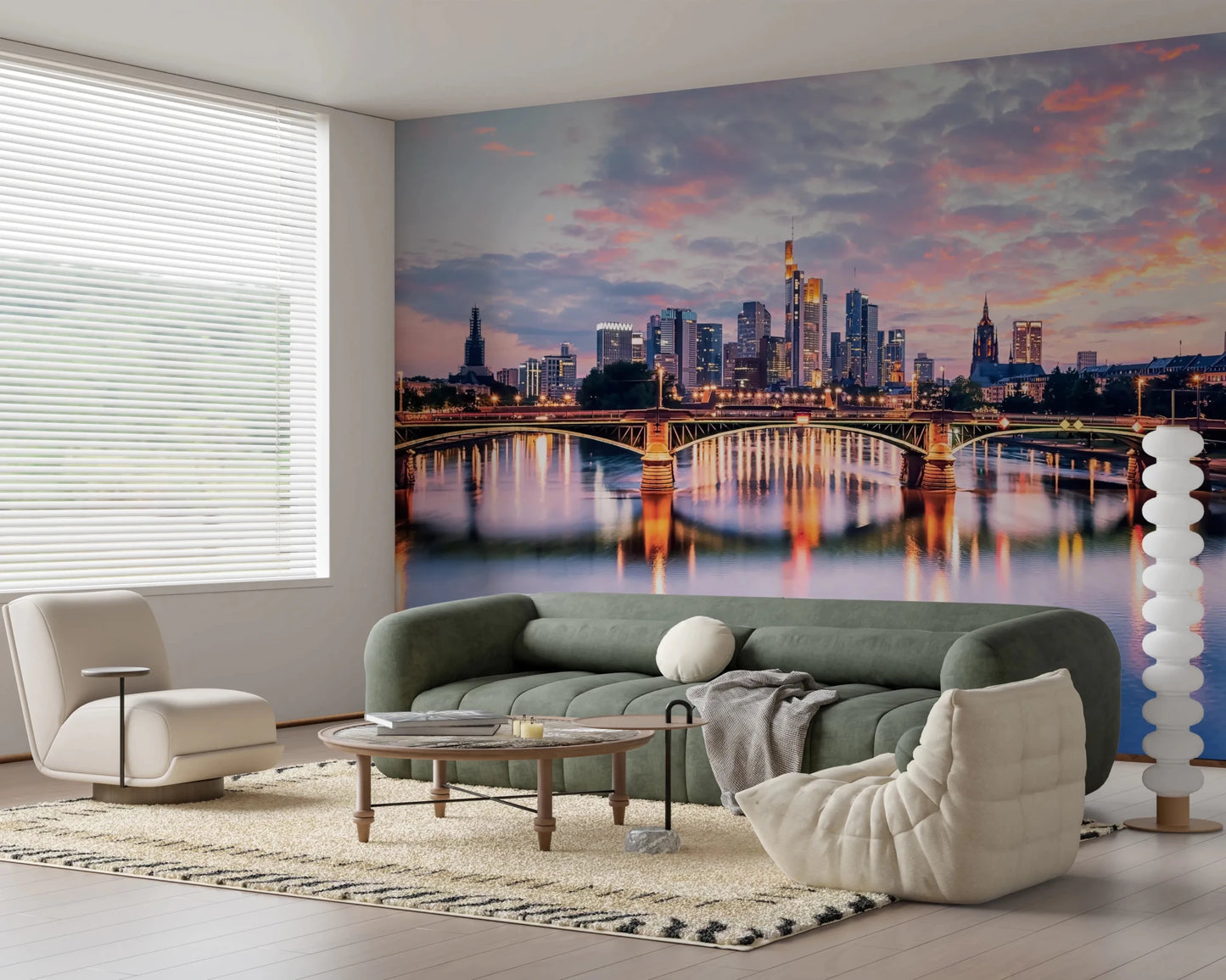 Frankfurt Dawn wallpaper mural of the pink dusk skyline and river behind a green sofa and cream Togo chair