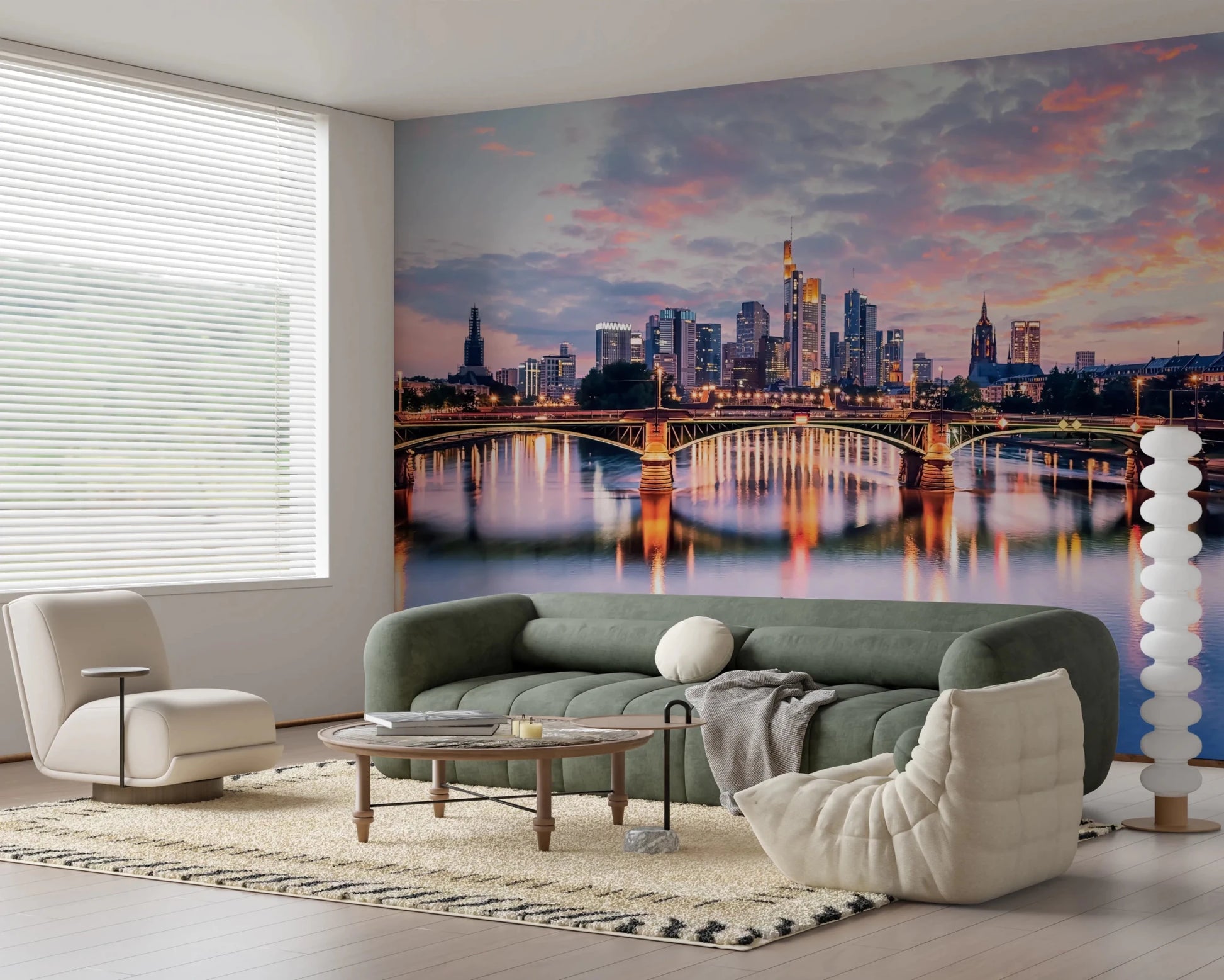 Frankfurt Dawn wallpaper mural of the pink dusk skyline and river behind a green sofa and cream Togo chair