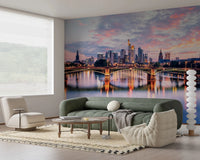 Frankfurt Dawn wallpaper mural of the pink dusk skyline and river behind a green sofa and cream Togo chair