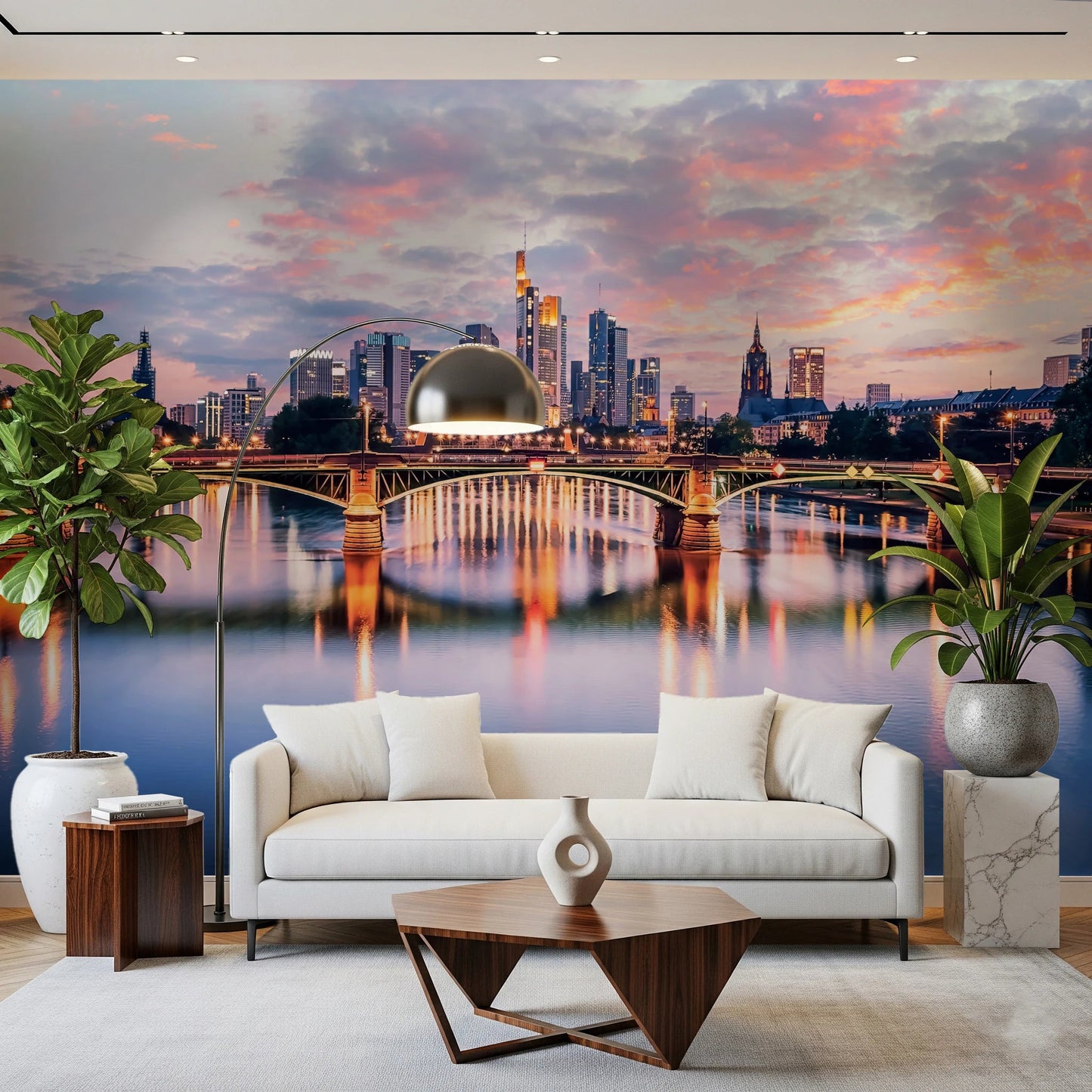 Frankfurt Dawn wallpaper mural with pink dusk clouds over the Main bridge behind a white sofa and tall plants