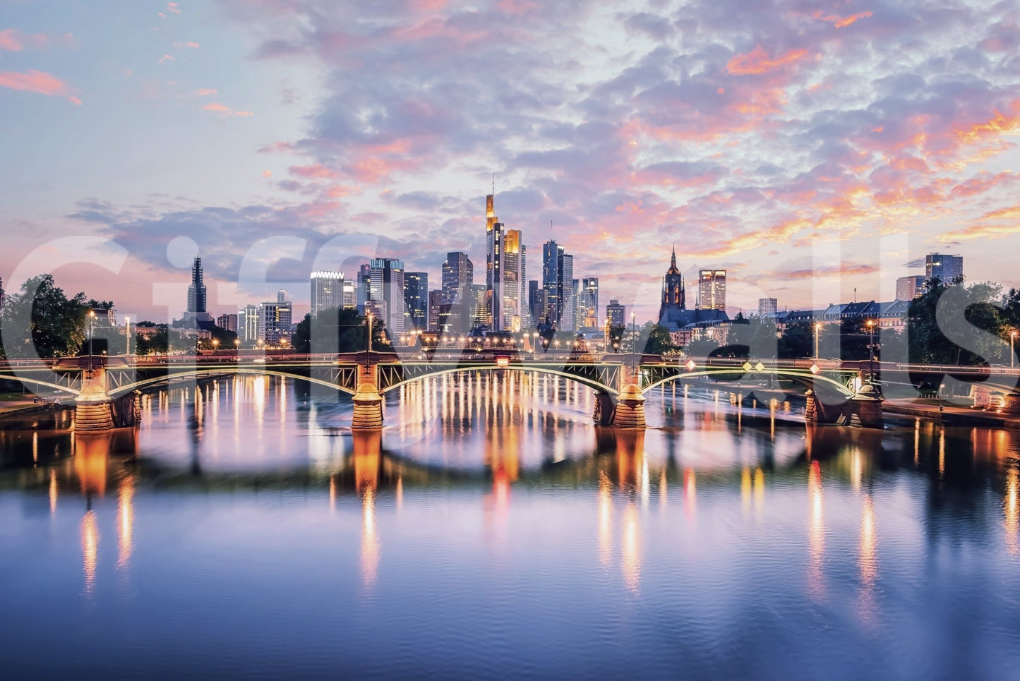 Frankfurt Dawn wallpaper mural shown as a full-wall scene of the pink sunset skyline and arched river bridge