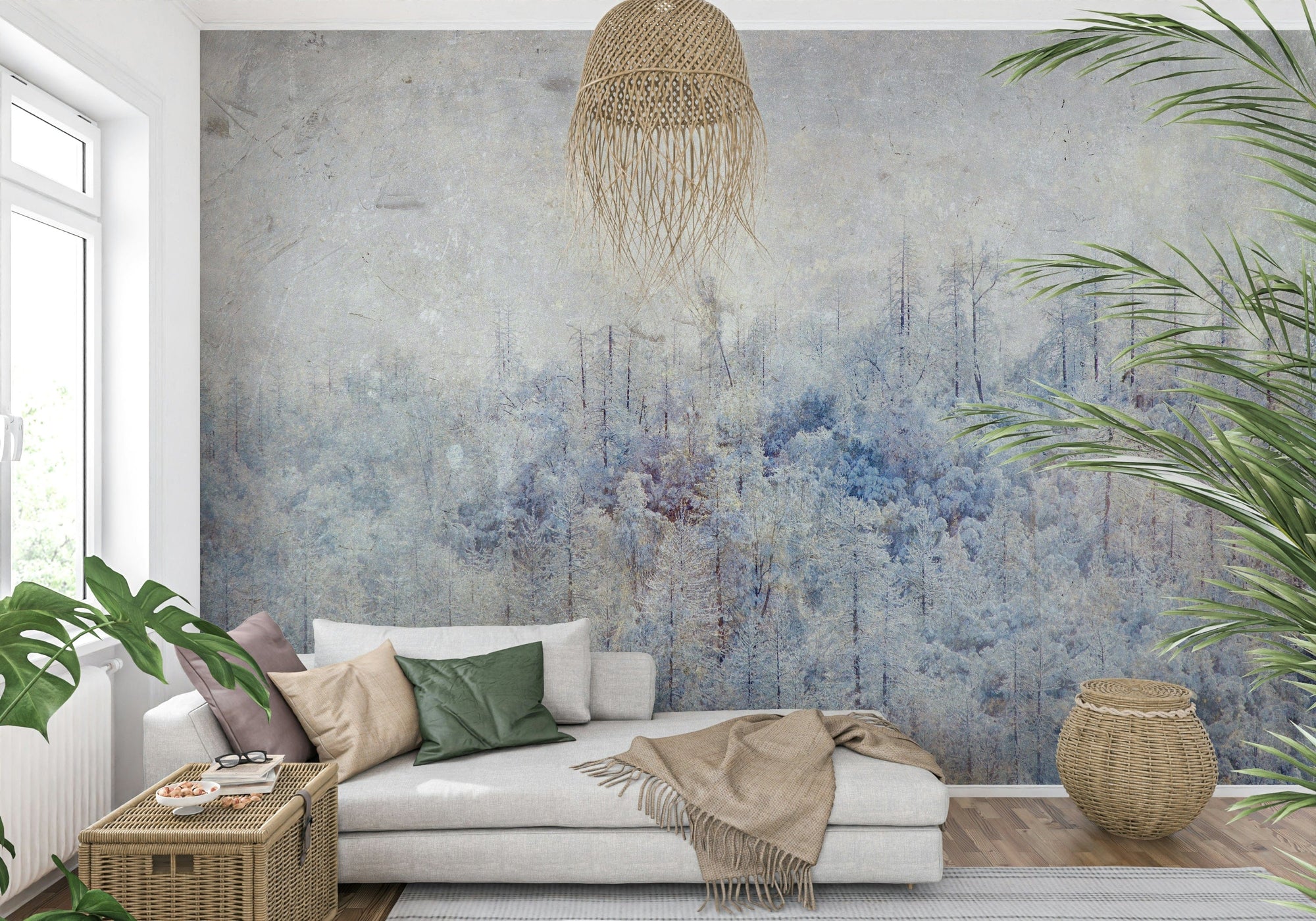 Frosted Forest Dream wallpaper mural of pale blue winter woodland behind a white daybed with green pillows