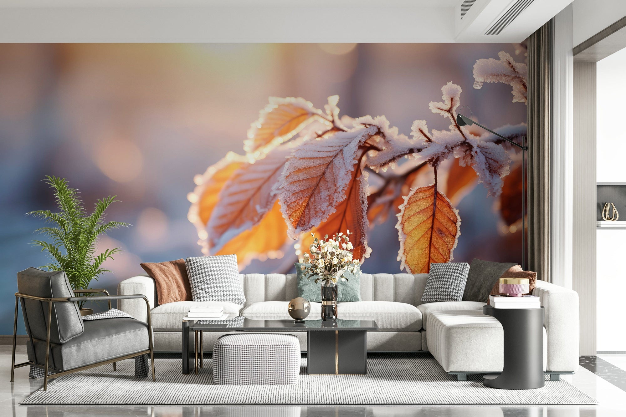 Gilded Frost wallpaper mural of frost-rimmed amber leaves behind a cream sofa and grey armchair in a living room