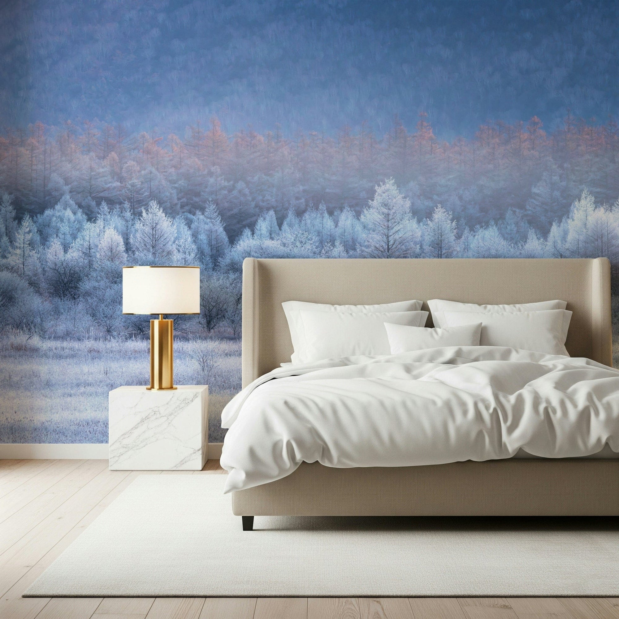 Frozen Dawn Vista wallpaper mural of a frosty blue forest at dawn behind a beige headboard bed with gold lamp