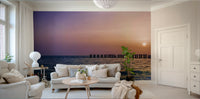 Peaceful ocean mural with golden sky and waves

