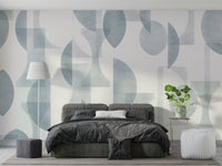 An angled shot of a wall with blue wallpaper

