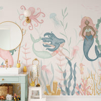 Dreamy Aquatic Ballet wallpaper with mermaids and an octopus sconce above a mint vanity in a kids bathroom