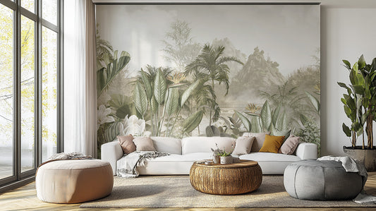 Ethereal Jungle Panorama mural in misty sage greens behind a white sofa and round woven coffee table in a living room