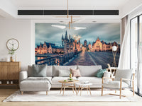 Twilight glow Ghent wall mural featuring cobblestone street and golden windows, European city wallpaper