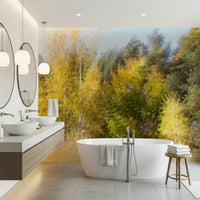 Blurred forest wallpaper in reading nook, warm color palette, cozy chair