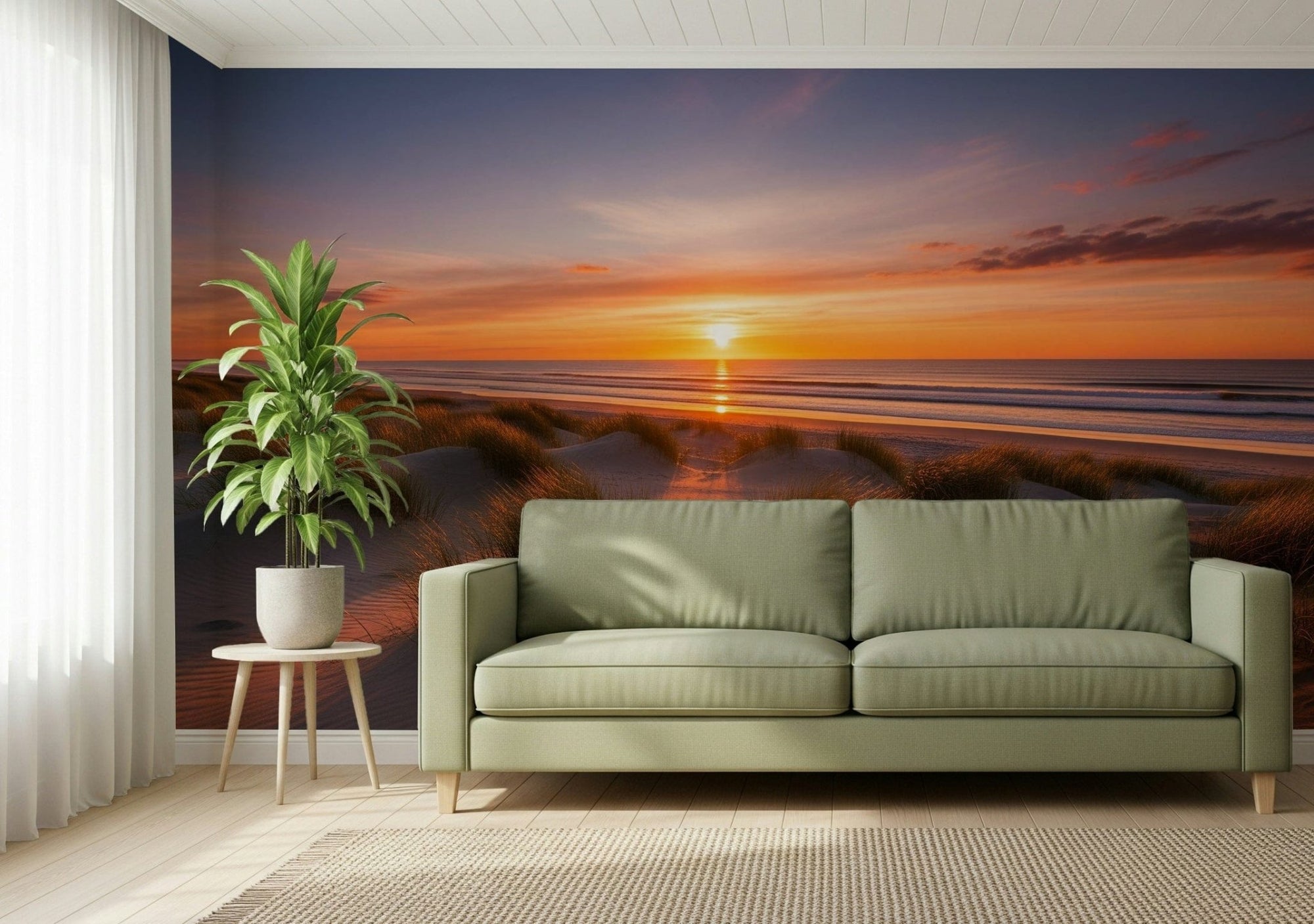 Golden Dune Dawn wallpaper mural of a beach sunset over the ocean behind a sage green sofa in a living room