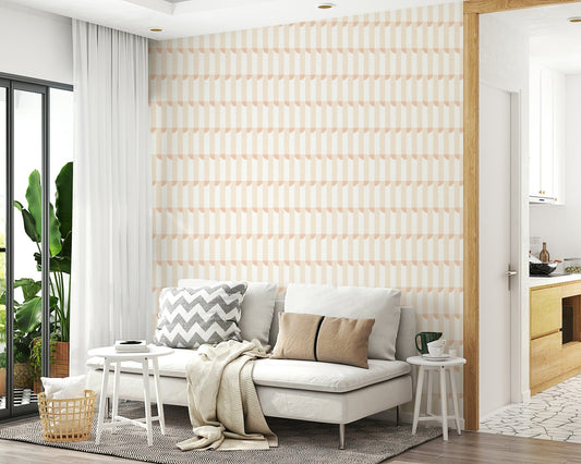 Golden sand wallpaper behind a white sofa with grey chevron and beige cushions and a knit throw
