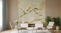 A modern abstract Marble Wallpaper featuring warm ecru sand tones intersected by elegant golden veins.