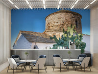 A beautiful panoramic wall mural of a seaside church.

