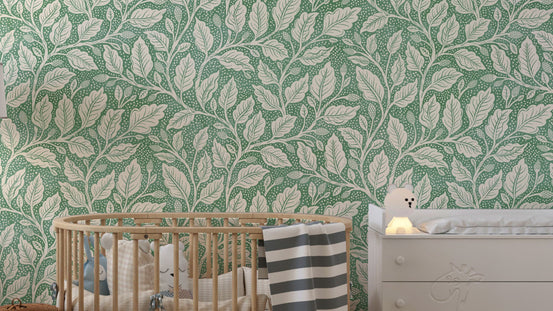 Green Budding Branches wallpaper with cream leafy vines on green in a nursery with a wooden crib and white dresser