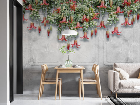 Hanging Exotic Flowers wallpaper mural with red blooms on gray concrete behind a wood dining table and sofa