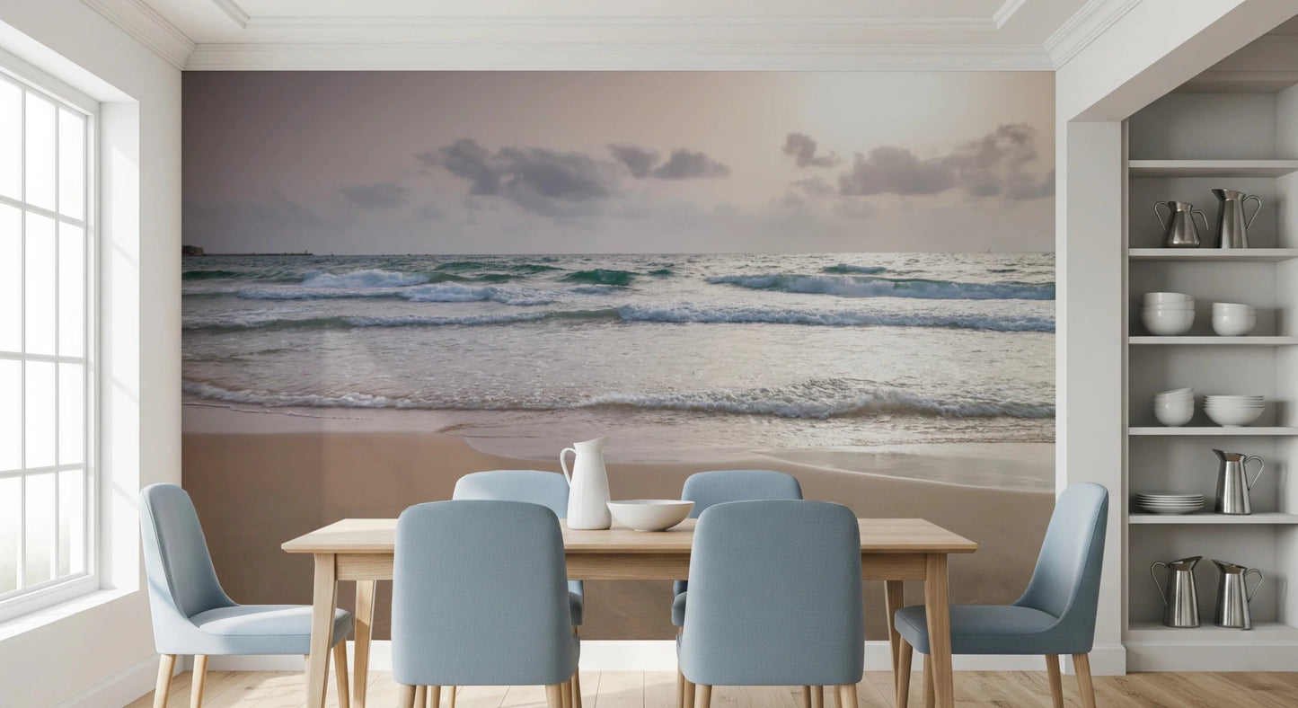 Happy Beach Vibes wallpaper mural of soft ocean waves behind a wood dining table with light blue chairs