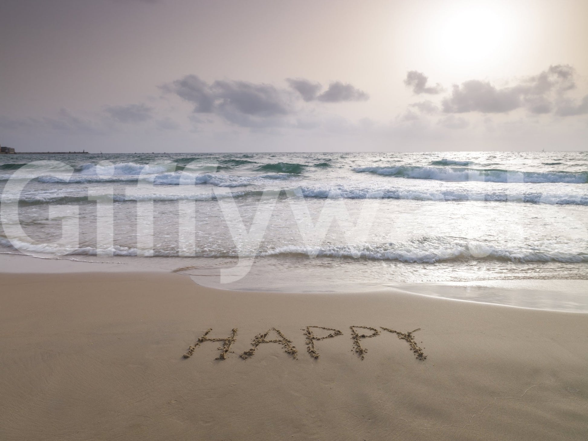 Happy Beach Vibes wallpaper mural shown full-wall, a dusk beach with HAPPY written in the sand and rolling waves