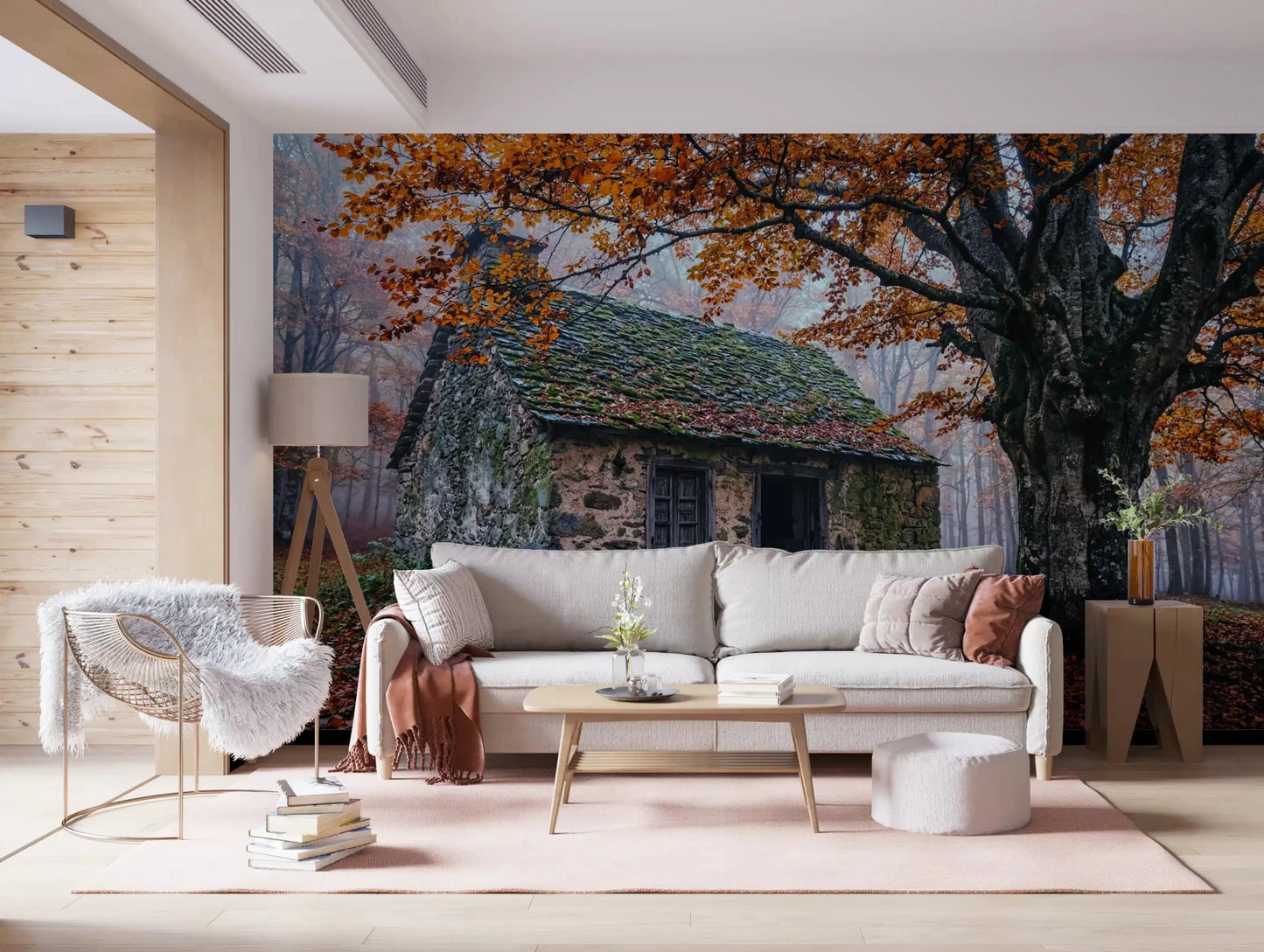 Stone cottage wall mural framed by autumn branches and a soft misty woodland