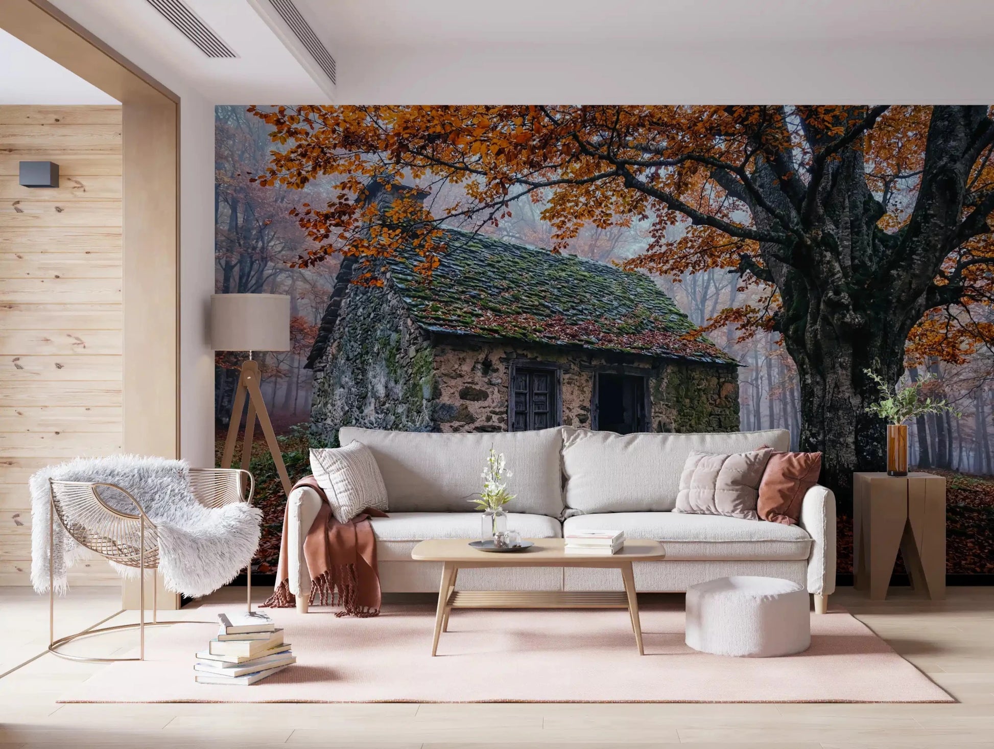 Stone cottage wall mural framed by autumn branches and a soft misty woodland
