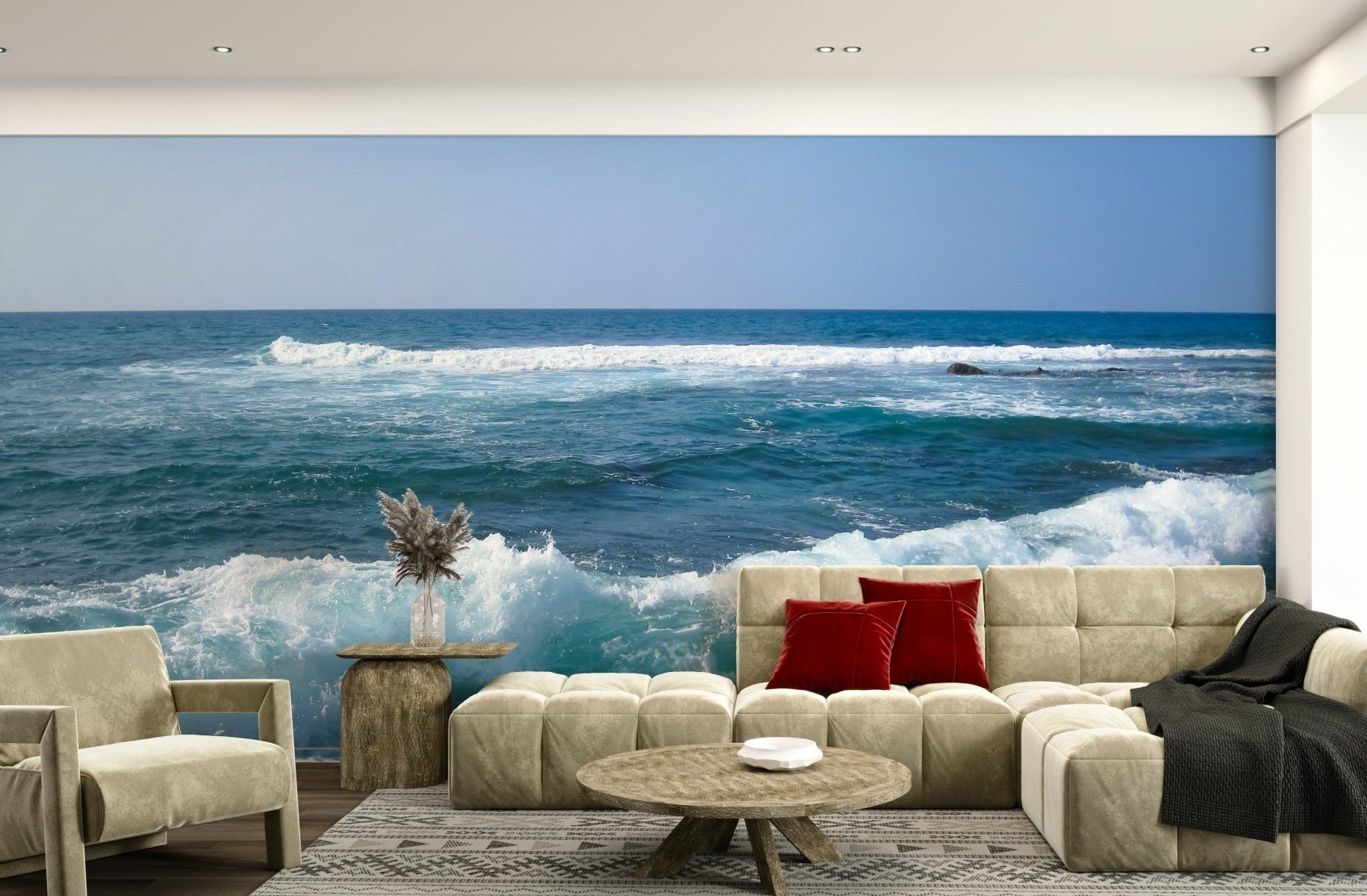 Hawaii Rocky Shore wallpaper mural of turquoise ocean waves and blue sky behind a beige sectional sofa in a living room